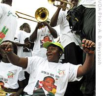 A member of Friends for Obama, Ghana dances to music of a brass band at a recent rally in Accra, 06 Jul 2009