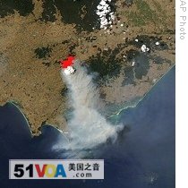 Image provided by NASA shows smoke spreading from fire (outlined in red) that appears to be burning in small area of forest in Victoria's Gippsland region, Australia (file)