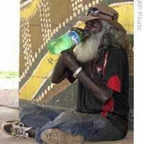 An aboriginal man drinks a beverage outside a store in the remote outback town of Wadeye in the Northern Territory, Australia, 01 Jun 2009