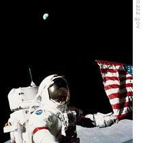 Apollo 17 astronaut Eugene Cernan with the American flag, and Earth in the lunar sky above him