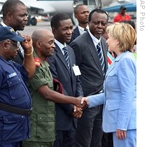 US Secretary of State Hillary Clinton, right, is greeted by members of the government on arrival at the airport in Kinshasa, Congo, 10 Aug 2009