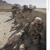US Marines take a position on a rooftop while fighting the Taliban in the village of Dahaneh, in the Helmand Province of Afghanistan, 12 Aug 2009