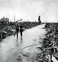 A file photo shows 2 people walking through Hiroshima destruction resulting from the 06 Aug 1945 detonation of the 1st atomic bomb