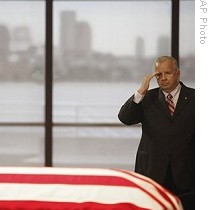 Mourner offers salute while standing near flag-draped casket of Sen. Edward M. Kennedy as he pays his respects at John F. Kennedy Presidential Library, in Boston, 28 Aug 2009 