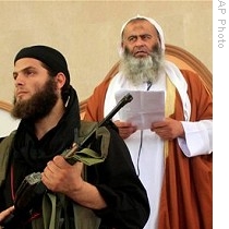 Members of militant Islamic group Jund Ansar Allah stand guard as Abdel-Latif Moussa speaks during Friday prayers in Rafah, 14 Aug 2009