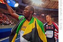 Usain Bolt (left) walking off track with American bronze medalist Wallace Spearmon, 20 Aug 2009