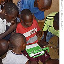 Boys practice their skills on computers donated by the One LapTop Per Child project