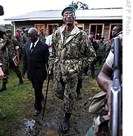 Rebel General Laurent Nkunda (C) walks in the courtyard of a house after speaking with the press in the town of Kitshoumba, 02 Nov 2008 