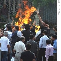 Supporters of defeated presidential candidate Mir Hossein Mousavi shout slogans as they face riot police during demonstration in Tehran, 20 Jun 2009