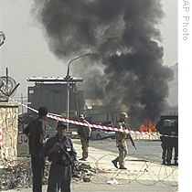 ISAF soldiers secure the site of the car bomb, outside the entrance to the military airport, in Kabul, Afghanistan, 08 Sep 2009