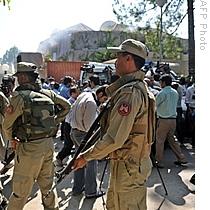 Pakistani paramilitary troops patrol in front of the United Nations office in Islamabad after a suicide blast, 05 Oct 2009