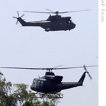 Pakistani army helicopters fly over headquarters after attack by gunmen in Rawalpindi, 10 Oct 2009 