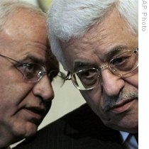 Palestinian President Mahmoud Abbas, right, consults with his aide Saeb Erekat, left, during a press conference (File)