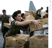 US Marines from 3rd Marine Expeditionary Brigade based in Okinawa, Japan, unload boxes of relief supplies intended for typhoon victims in Legazpi city, 12 Nov 2009