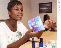 Shakara Walker shows a product her group of students is marketing at Junior Achievement offices in Atlanta, Georgia