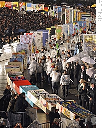 Fall of Berlin Wall is celebrated with display of giant dominos falling along wall's route, 9 Nov 2009