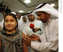 Saudi Arabia's health minister gives his 8-year-old daughter the H1N1 flu vaccine in Riyadh last week