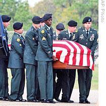 Soldiers carry the casket of Michael Grant Cahill, a physician's assistant and the only civilian among the 13 people killed in the shooting November 5 at the Army base at Fort Hood, Texas