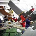 Volunteer Sally Murphy, center, works on a float named "Tuskegee Airmen" in Pasadena, Calif., 28 Dec 2009, in preparation for the Rose Parade