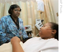 A nurse helps a patient at the Sickle Cell Center at Truman Medical Center in Kansas City