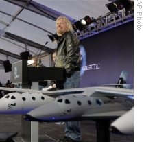 Richard Branson presents a model of the SpaceShipTwo
