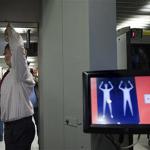 An employee of Schiphol stands inside a body scanner during a demonstration at a press briefing at Schiphol airport, Netherlands, Monday, Dec. 28, 2009. 