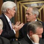 Sen. Christopher Dodd, D-CT., left standing, talks with Sen Bob Corker, R-TN., right standing, during a Committee on Banking, Housing and Urban Affairs executive session to vote on the reappointment of Federal Reserve Board Chairman Ben Bernanke on Capito