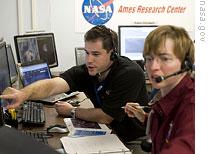 LCROSS scientists Anthony Colaprete and Kim Ennico study early results from the lunar impact experiment