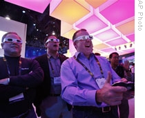 CES attendees use 3-D glasses to play a game