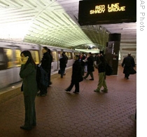 Riders wait for a train at the Metro Center station in Washington, D.C.