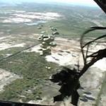 This image taken from video shows relief supplies parachuting from a US Air Force cargo plane flying over Haiti, 19 January 2010 Author: US Air Force 