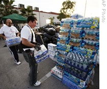 Volunteers deliver donation for Haiti victims at a drop off point in Hialeah Gardens, Fla.