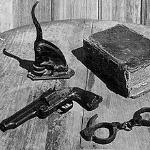 The tools of Texas lawman Judge Roy Bean: a notary seal, a book of law, handcuffs and a gun