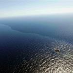 In this aerial photo taken over the Gulf of Mexico, a boat and crew work in oil which leaked from a pipeline at the Deepwater Horizon oil rig off the coast of Louisiana, 26 Apr 2010