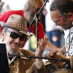 Dr. John talks with bassist George Porter, right, as they perform with the Voice of the Wetlands All Stars at the New Orleans Jazz and Heritage Festival in New Orleans, 25 April 2010