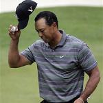 Tiger Woods tips his hat to the crowd after his first round this week in the Masters
