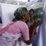 A woman wails next to a photo of her grand daughter, who died in an Air India Express plane crash in Mangalore