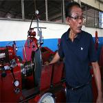 Red shirt businessman Narong Meephet at his machine shop in Udon Thani