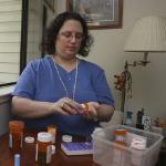 Melody Nolan, who suffers from systemic lupus, prepares her daily medications at her home in Sacramento, California