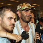 A crew member of the Turkish-flagged 'Mavi Marmara' ship, wearing cap, center, is surrounded by media upon his arrival from Israel to the Istanbul airport, 01 Jun  2010
