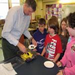 Fourth grade teacher Mark Rampone dishes out the fruit snack for his students.