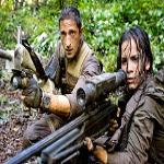 Royce (Adrien Brody) and Isabelle (Alice Braga) take aim during their desperate battle against alien Predators
