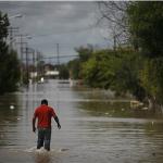 A man walks trough a flooded street in the Mexican town of Ciudad Anahuac in July. About 18,000 people were evacuated from the area after rains that accompanied Hurricane Alex. 