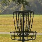 Instead of shooting for a hole on the green, disc golf players aim for a raised metal basket.