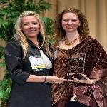 Layli Miller-Muro, (right), executive director of the Tahirih Justice Center, receives a 2010 BRAVA! Women Business Achievement Award. 