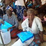 Women receive mosquito nets in Sesheke, Zambia, in September