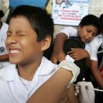A boy in Lima, Peru, reacts to a hepatitis B vaccine 