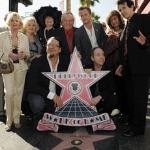A group of celebrities pose in front of the star for legendary illusionist Harry Houdini on the Hollywood Walk of Fame.