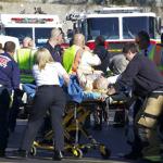 Emergency workers treat a shooting victim near the shopping center where the attack took place