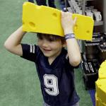 Henry Moser, 5, of McKinney, Texas, tries on a Green Bay Packers' 
